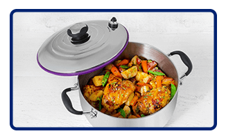 Pan with lid to the side showing chicken and fresh veggies inside pot